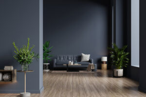 Interior of living room with sofa on empty dark blue wall backgr